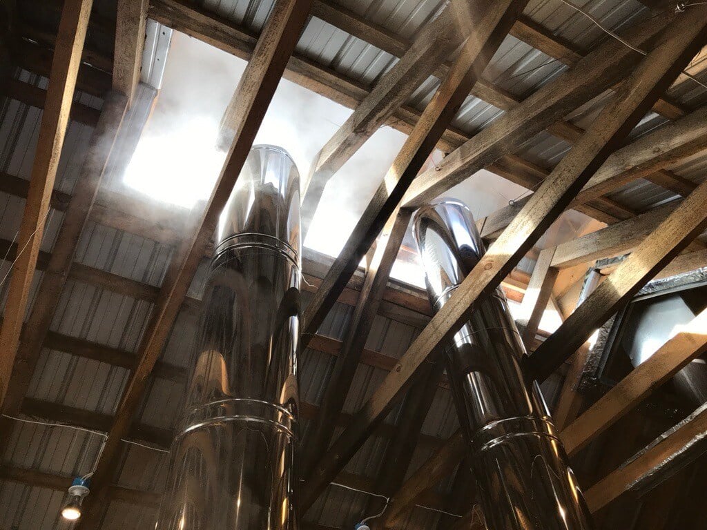 image of the inside of a Vermont Sugar Shack looking up as team coming our of the smokestacks